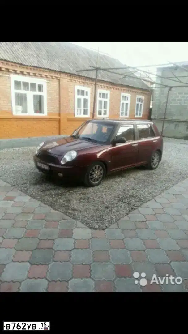 Фото автомобиля LIFAN SMILY, 2011 — госномер Т077НВ30. Цвет: ТЕМНО - ВИШНЕВЫЙ