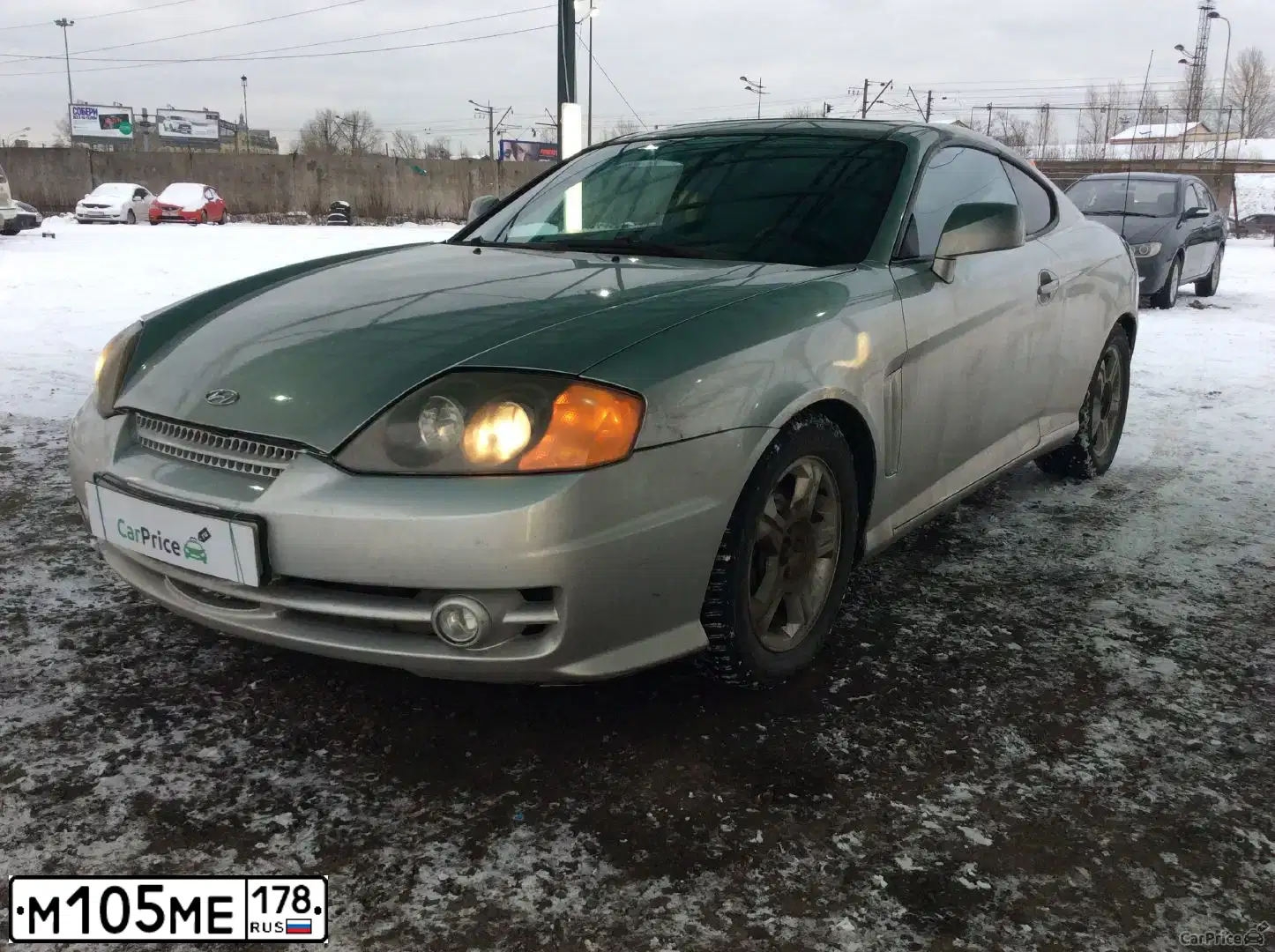 Фото автомобиля HYUNDAI TIBURON, 2002 — госномер М105МЕ178. Цвет: ЧЕРНЫЙ