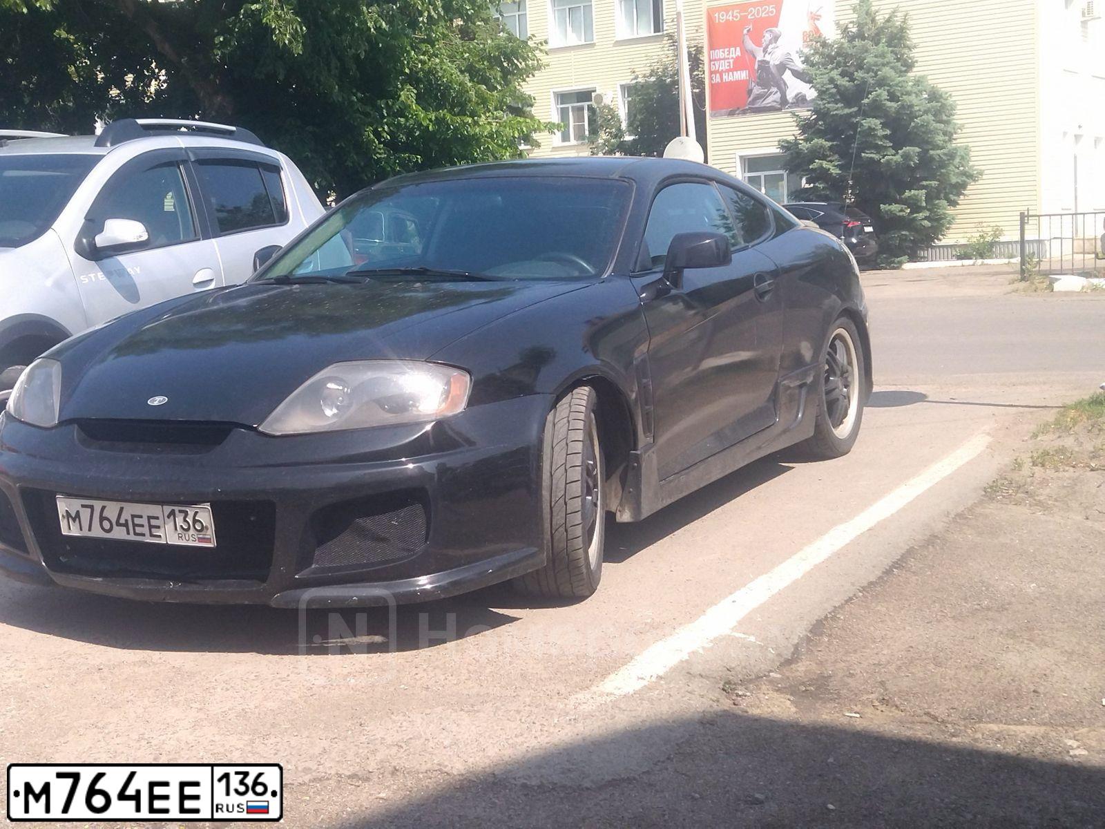 Фото автомобиля HYUNDAI TIBURON, 2005 — госномер М764ЕЕ136. Цвет: ЧЕРНЫЙ