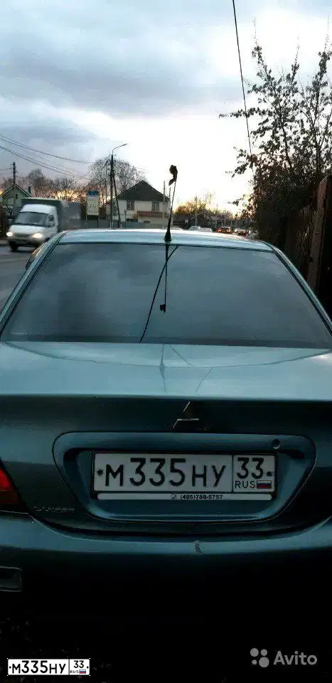 Фото автомобиля MITSUBISHI LANCER, 2006 — госномер М335НУ33. Цвет: СВЕТЛО-СЕРО-ЗЕЛЕНЫЙ