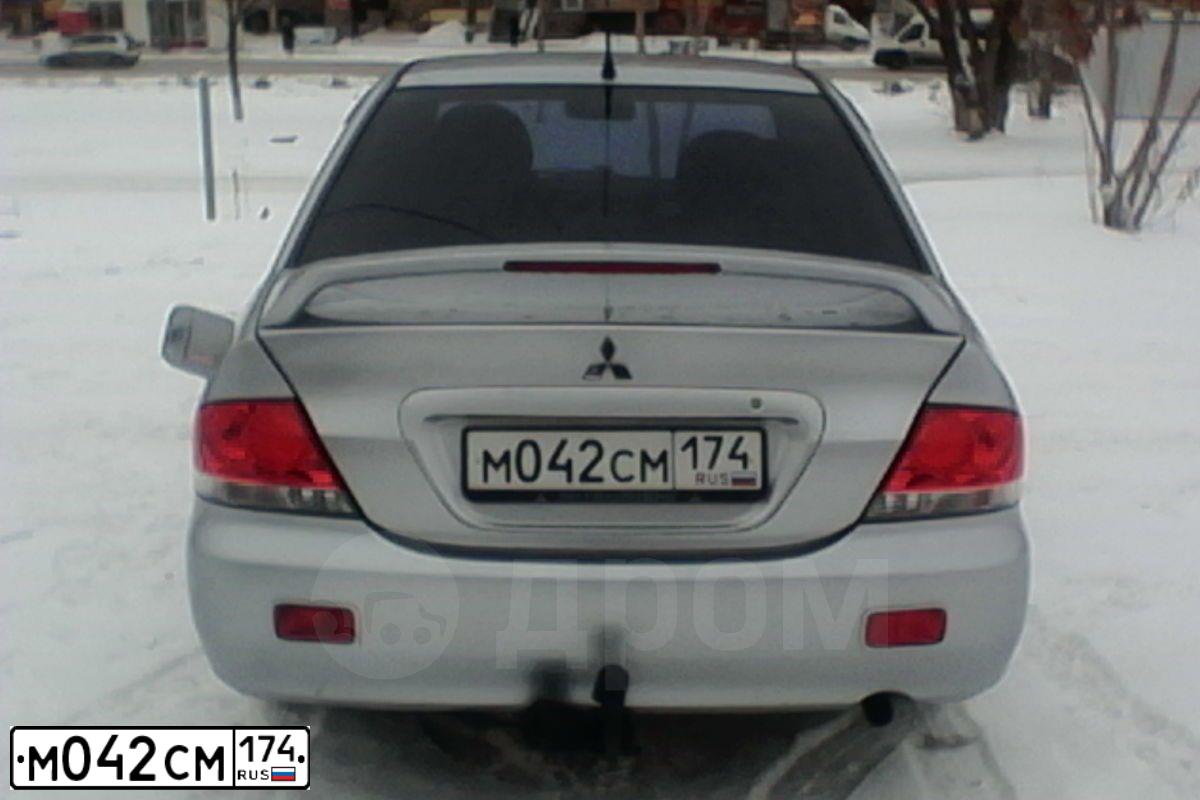 Фото автомобиля MITSUBISHI LANCER, 2006 — госномер М042СМ174. Цвет: Серебристый