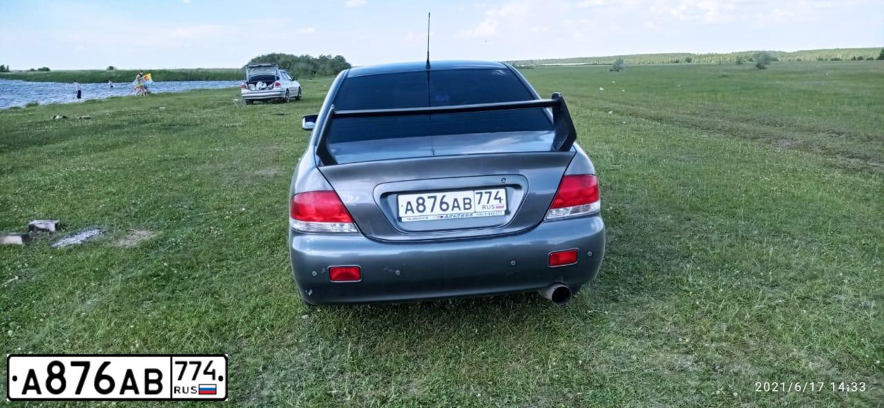 Фото автомобиля MITSUBISHI LANCER, 2005 — госномер К149КК774. Цвет: СЕРЫЙ