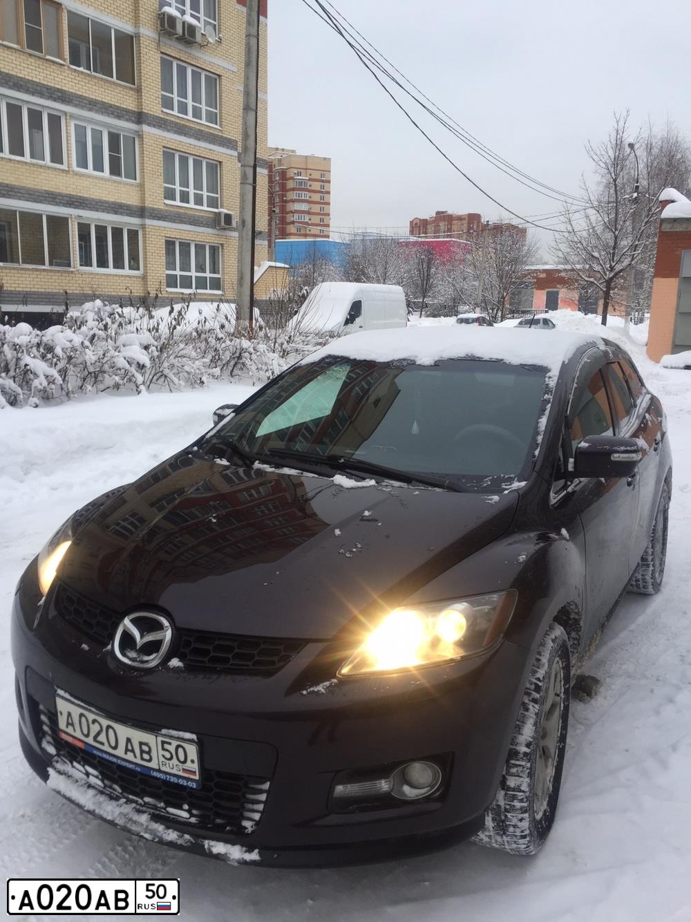 Фото автомобиля MAZDA CX-7, 2008 — госномер М100ОТ199. Цвет: ВИШНЕВЫЙ ТЕМНЫЙ