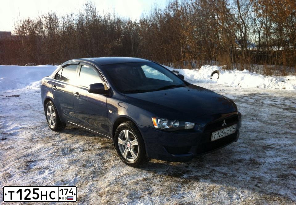 Фото автомобиля MITSUBISHI LANCER, 2011 — госномер Т125НС174. Цвет: синий