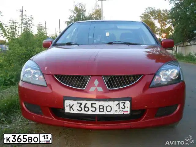 Фото автомобиля MITSUBISHI LANCER, 2004 — госномер М770АР13. Цвет: Красный