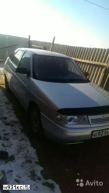 Фото автомобиля LADA 2112, 2006 — госномер Н931КС30. Цвет: СВЕТЛО-СЕРЕБРИСТЫЙ