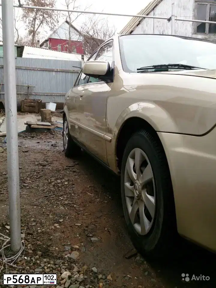 Фото автомобиля MAZDA PROTEGE, 2001 — госномер Т012ОТ102. Цвет: БЕЖЕВЫЙ