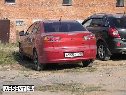 Фото автомобиля MITSUBISHI LANCER, 2010 — госномер А555УТ40. Цвет: Красный