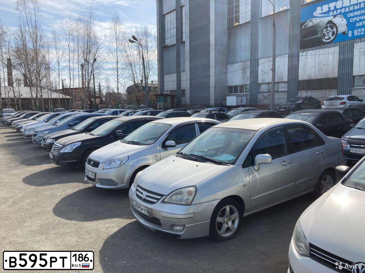 Фото автомобиля SUZUKI LIANA, 2005 — госномер К100АР186. Цвет: СЕРЫЙ