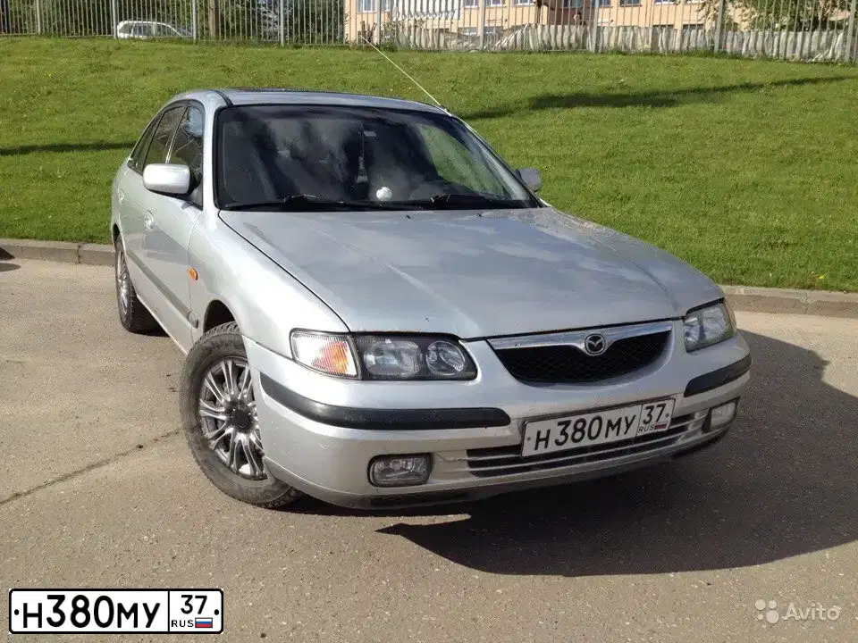 Фото автомобиля MAZDA 626, 1998 — госномер С099ОТ40. Цвет: СЕРЫЙ