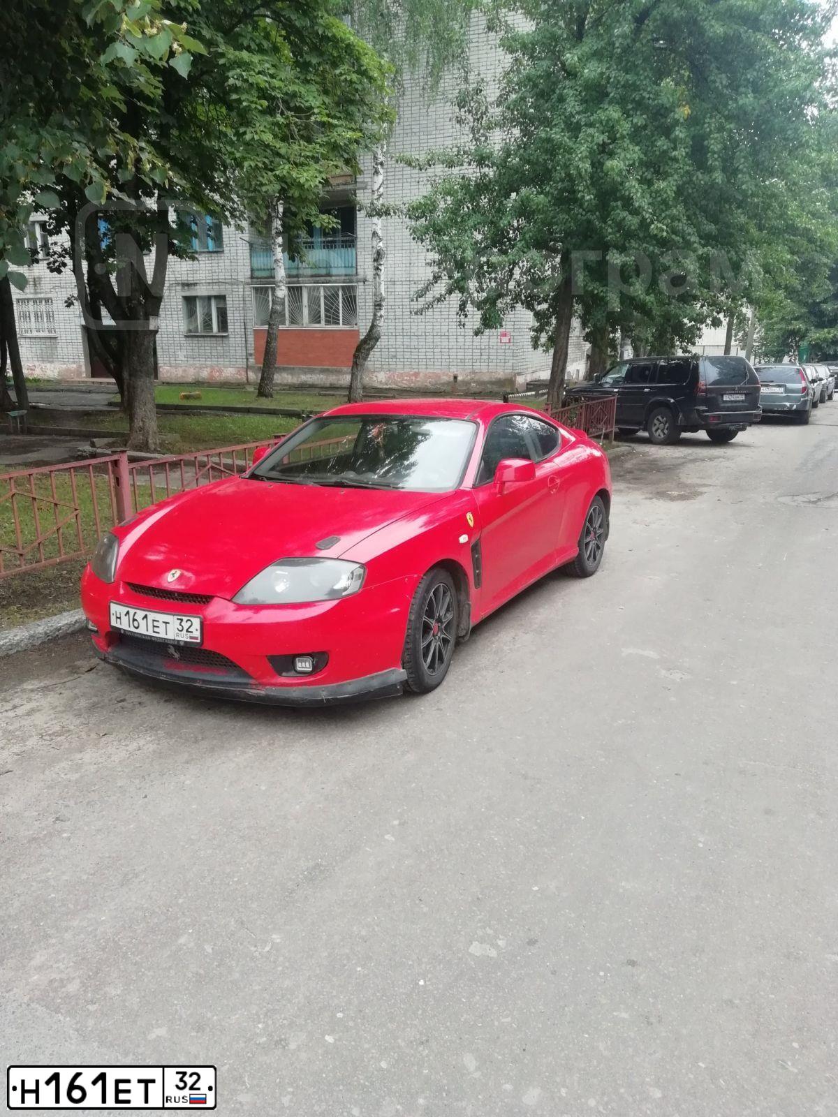 Фото автомобиля HYUNDAI /S-/COUPE / TUSCANI, 2006 — госномер Н161ЕТ32. Цвет: КРАСНЫЙ