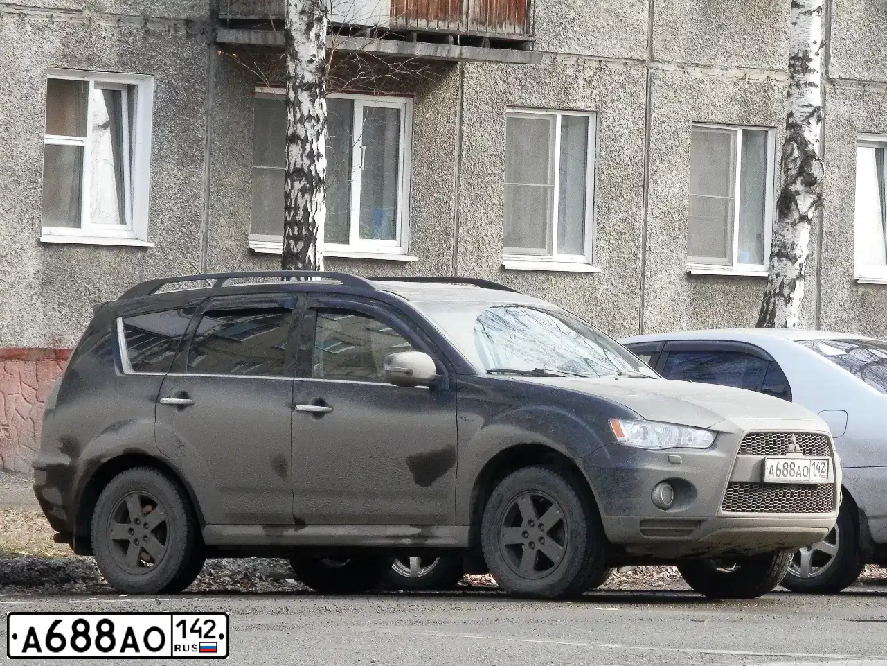 Фото автомобиля MITSUBISHI OUTLANDER, 2011 — госномер Р145СТ124. Цвет: ЧЕРНЫЙ