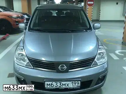 Фото автомобиля NISSAN TIIDA, 2008 — госномер Н747УТ174. Цвет: СЕРЫЙ