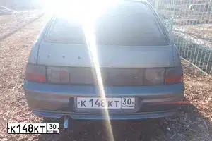 Фото автомобиля LADA 2112 LADA, 2007 — госномер К148КТ30. Цвет: средний серо-зеленый металлик