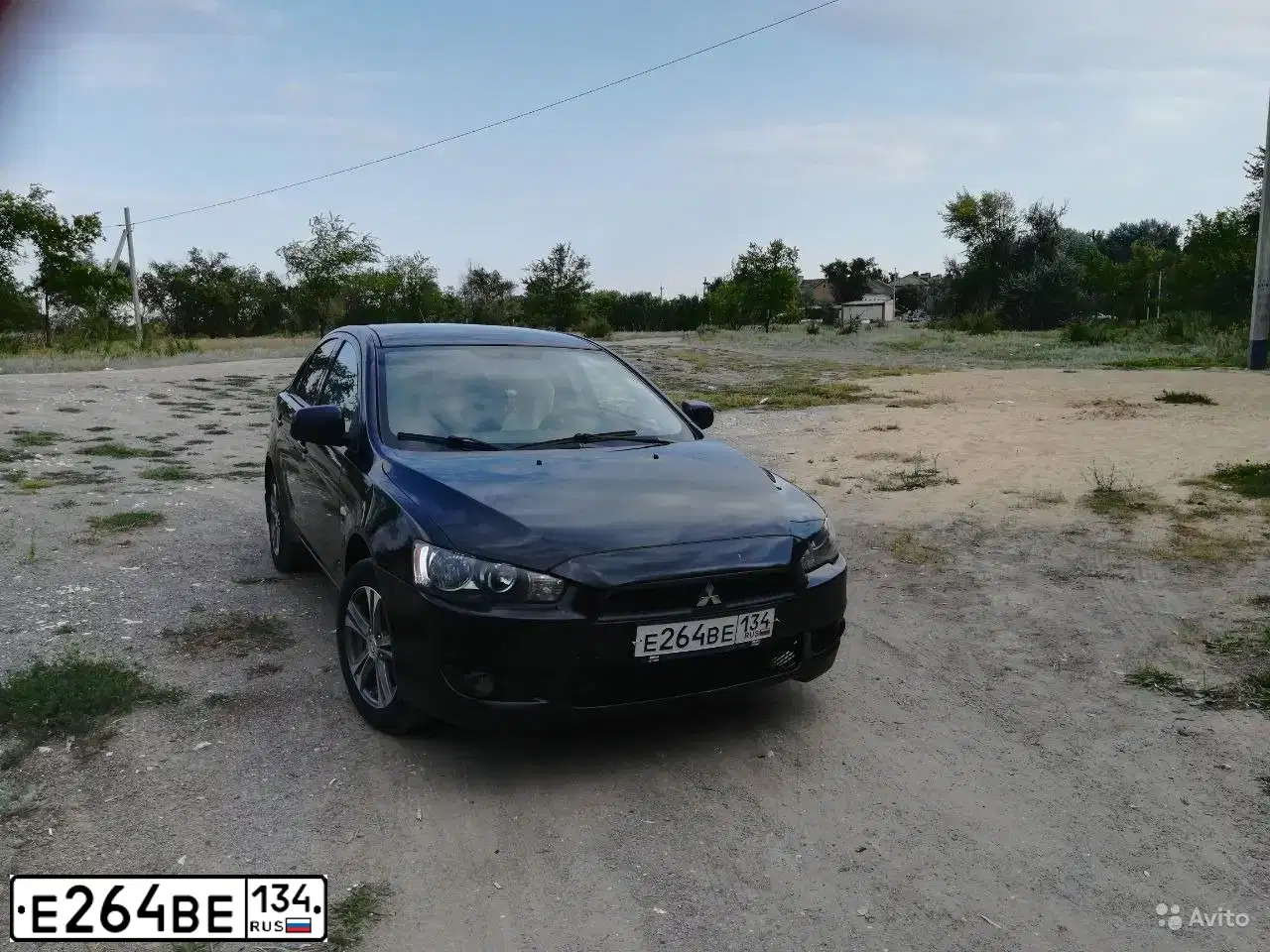 Фото автомобиля MITSUBISHI LANCER, 2007 — госномер Е264ВЕ134. Цвет: ЧЕРНЫЙ