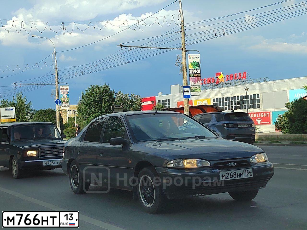 Фото автомобиля MAZDA A 3, 2005 — госномер М766НТ13. Цвет: Красный