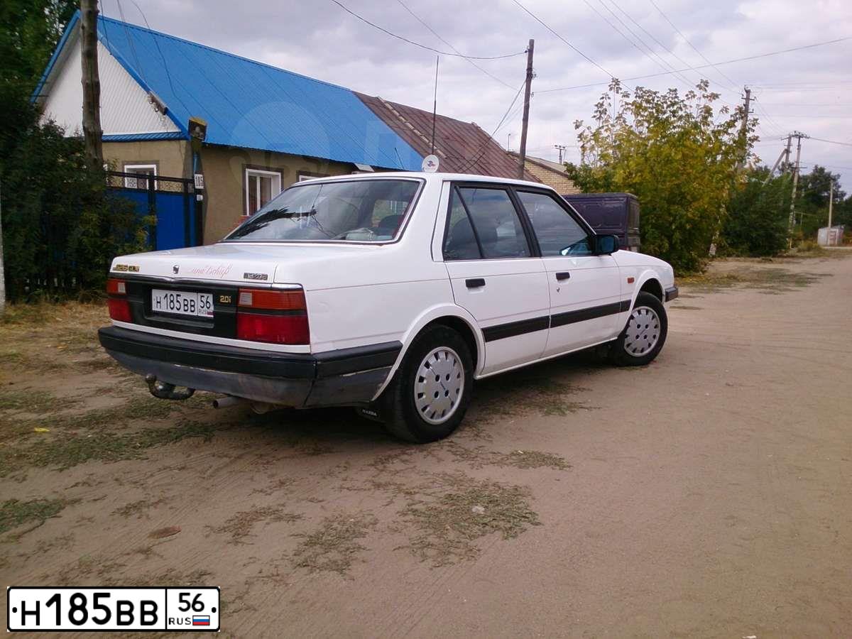 Фото автомобиля MAZDA 626, 1987 — госномер Н185ВВ56. Цвет: БЕЛЫЙ
