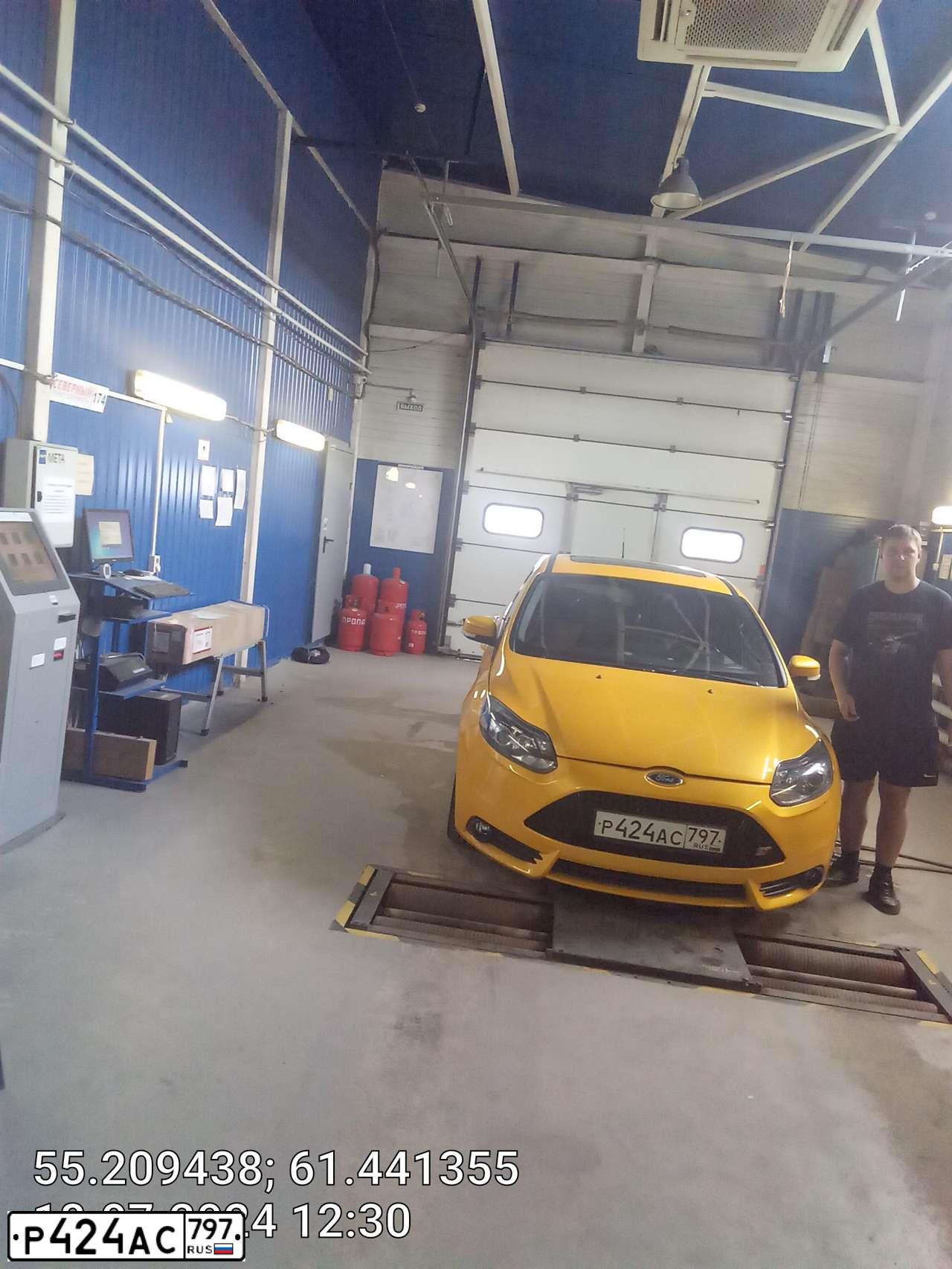 Фото автомобиля FORD FOCUS, 2012 — госномер К879УК77. Цвет: ОРАНЖЕВЫЙ