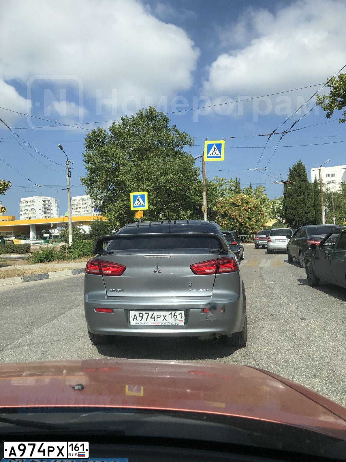 Фото автомобиля MITSUBISHI LANCER, 2012 — госномер А974РХ161. Цвет: СЕРЫЙ