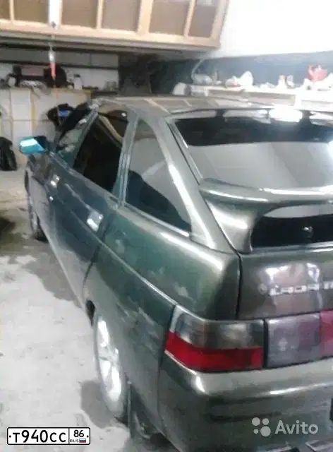 Фото автомобиля LADA 2112, 2004 — госномер Т940СС86. Цвет: ЗОЛОТИСТЫЙ ТЕМНО-ЗЕЛЕНЫЙ