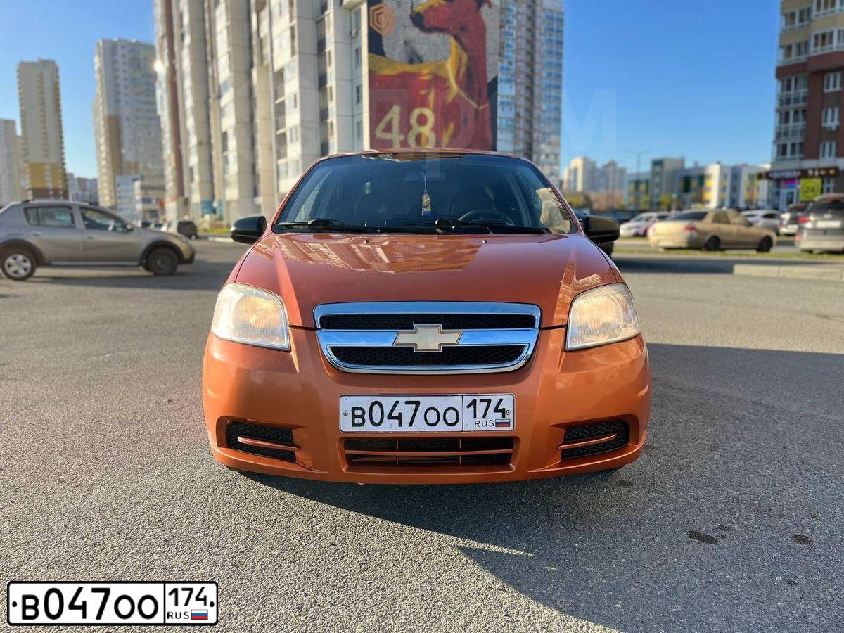 Фото автомобиля CHEVROLET AVEO, 2007 — госномер В047ОО174. Цвет: Оранжевый
