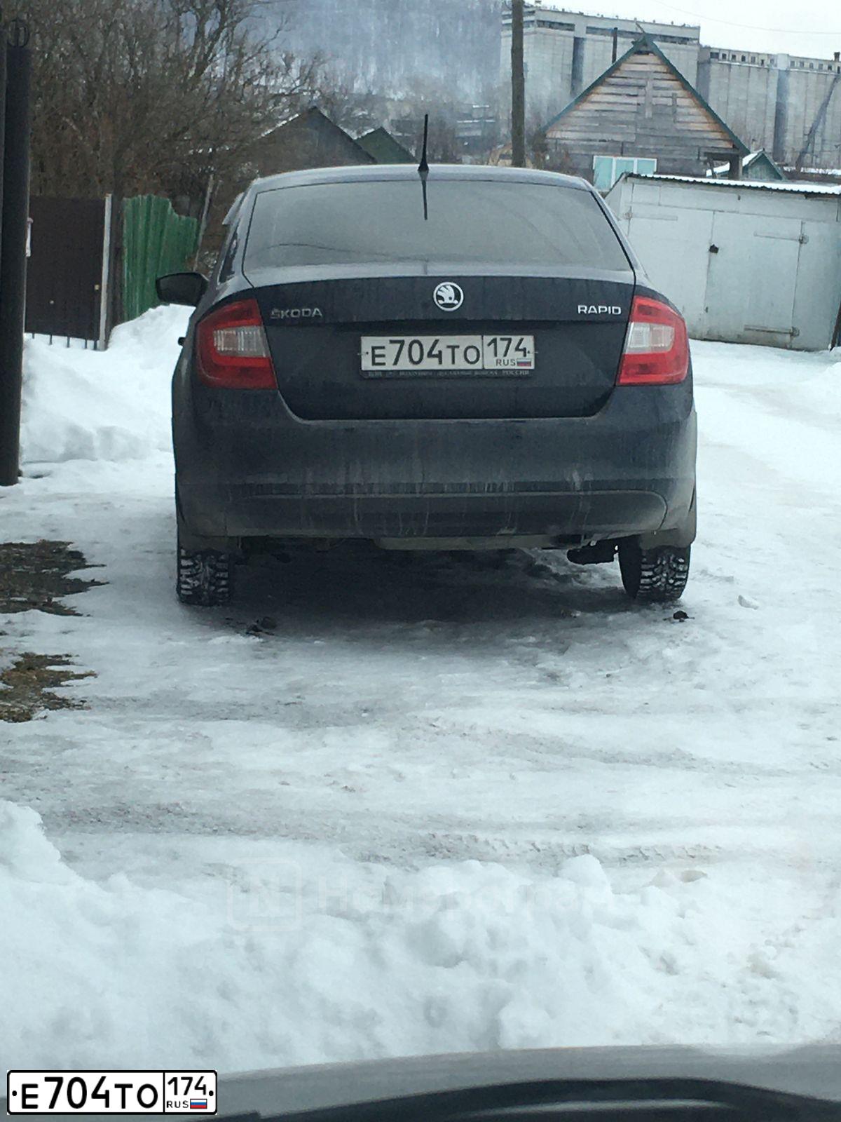 Фото автомобиля SKODA RAPID, 2014 — госномер Е704ТО174. Цвет: ТЕМНО-СИНИЙ