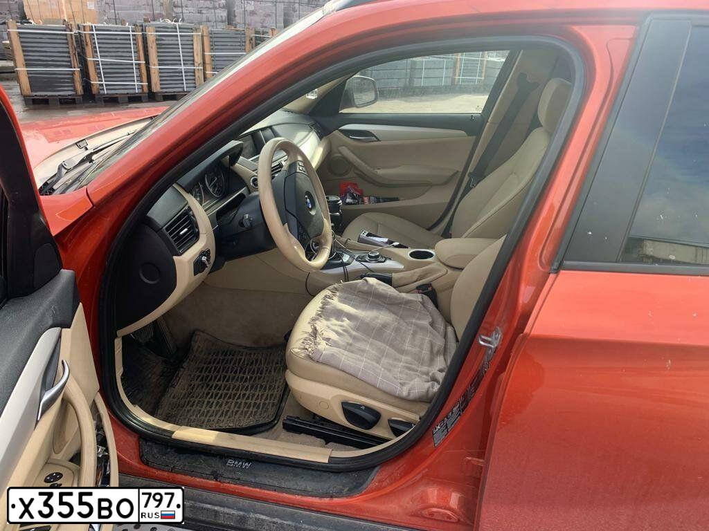 Фото автомобиля BMW X1, 2013 — госномер О778СТ77. Цвет: Оранжевый