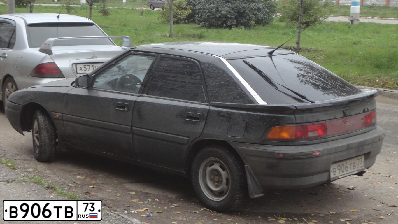 Фото автомобиля MAZDA 323, 1990 — госномер В906ТВ73. Цвет: ЧЕРНЫЙ