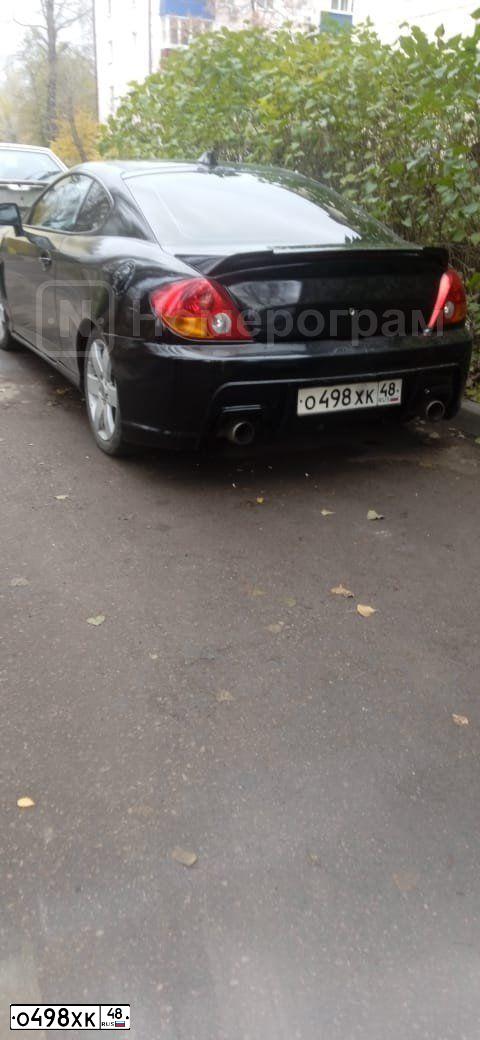 Фото автомобиля HYUNDAI /S-/COUPE / TUSCANI, 2002 — госномер О498ХК48. Цвет: ЧЕРНЫЙ
