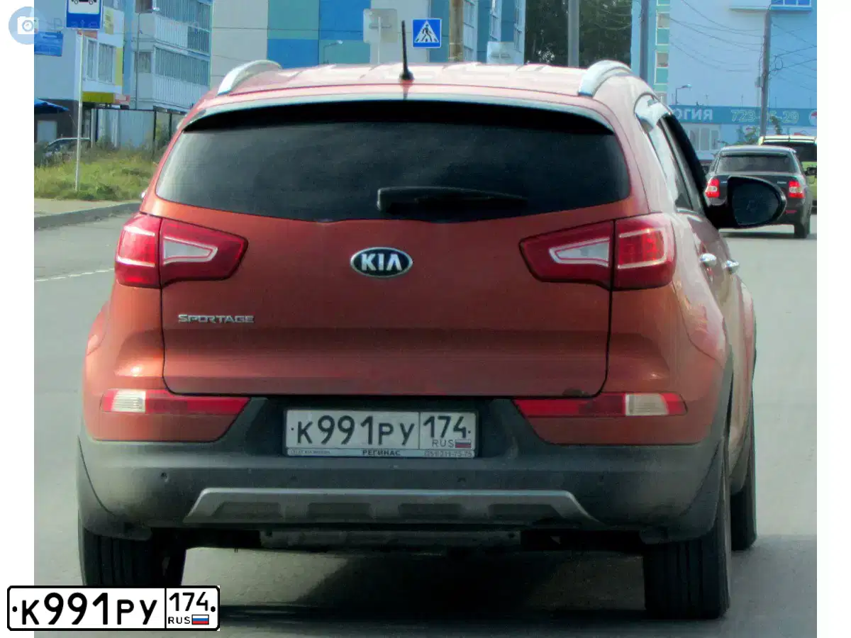 Фото автомобиля KIA SPORTAGE, 2012 — госномер К991РУ174. Цвет: ОРАНЖЕВЫЙ