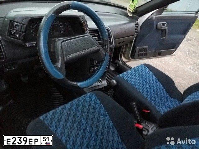 Фото автомобиля LADA 2112 LADA, 2005 — госномер Е239ЕР51. Цвет: Серебристо-желто-голубой