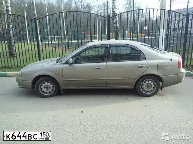 Фото автомобиля KIA SHUMA, 2004 — госномер Т125ХТ71. Цвет: БЕЖЕВЫЙ ТЕМНЫЙ