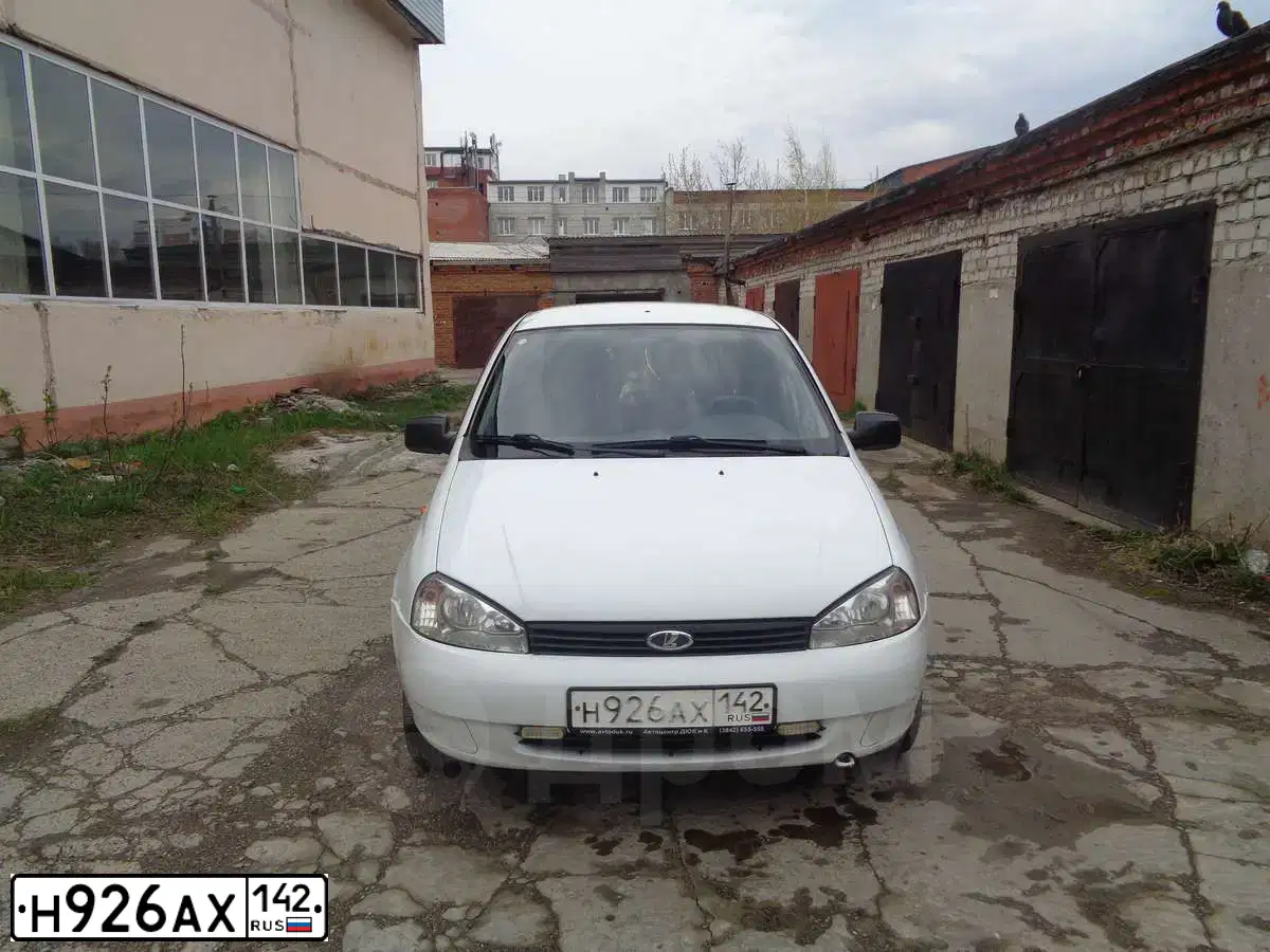 Фото автомобиля LADA 1119 KALINA, 2012 — госномер Е927ЕУ70. Цвет: Белый