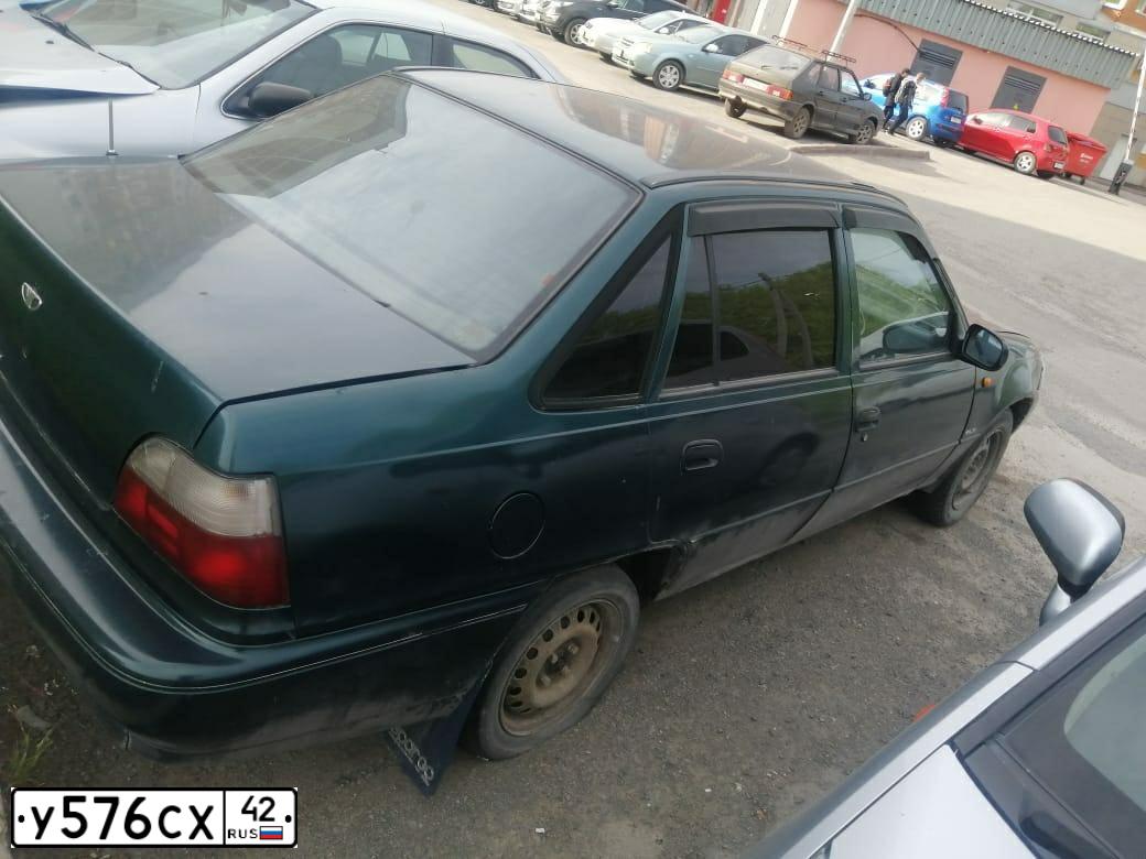 Фото автомобиля DAEWOO NEXIA, 1999 — госномер Т915НО142. Цвет: ПЕРЛАМУТРОВО-ЗЕЛЕНЫЙ