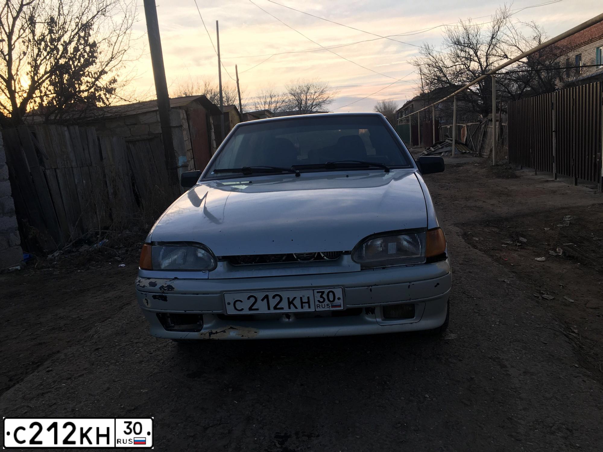 Фото автомобиля LADA 2114 SAMARA, 2004 — госномер С212КН30. Цвет: МОЛОЧНО-БЕЛЫЙ СЕРЕБРИСТЫЙ