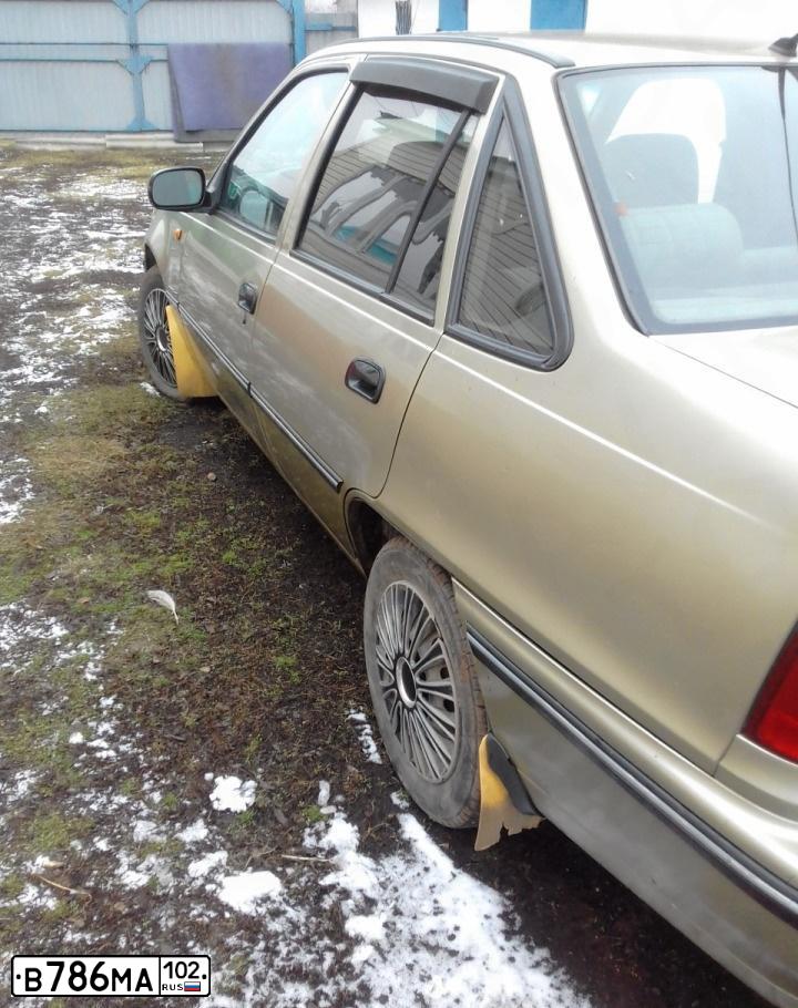 Фото автомобиля DAEWOO NEXIA, 2006 — госномер Н841СС702. Цвет: ПЕСОЧНО-БЕЖЕВЫЙ