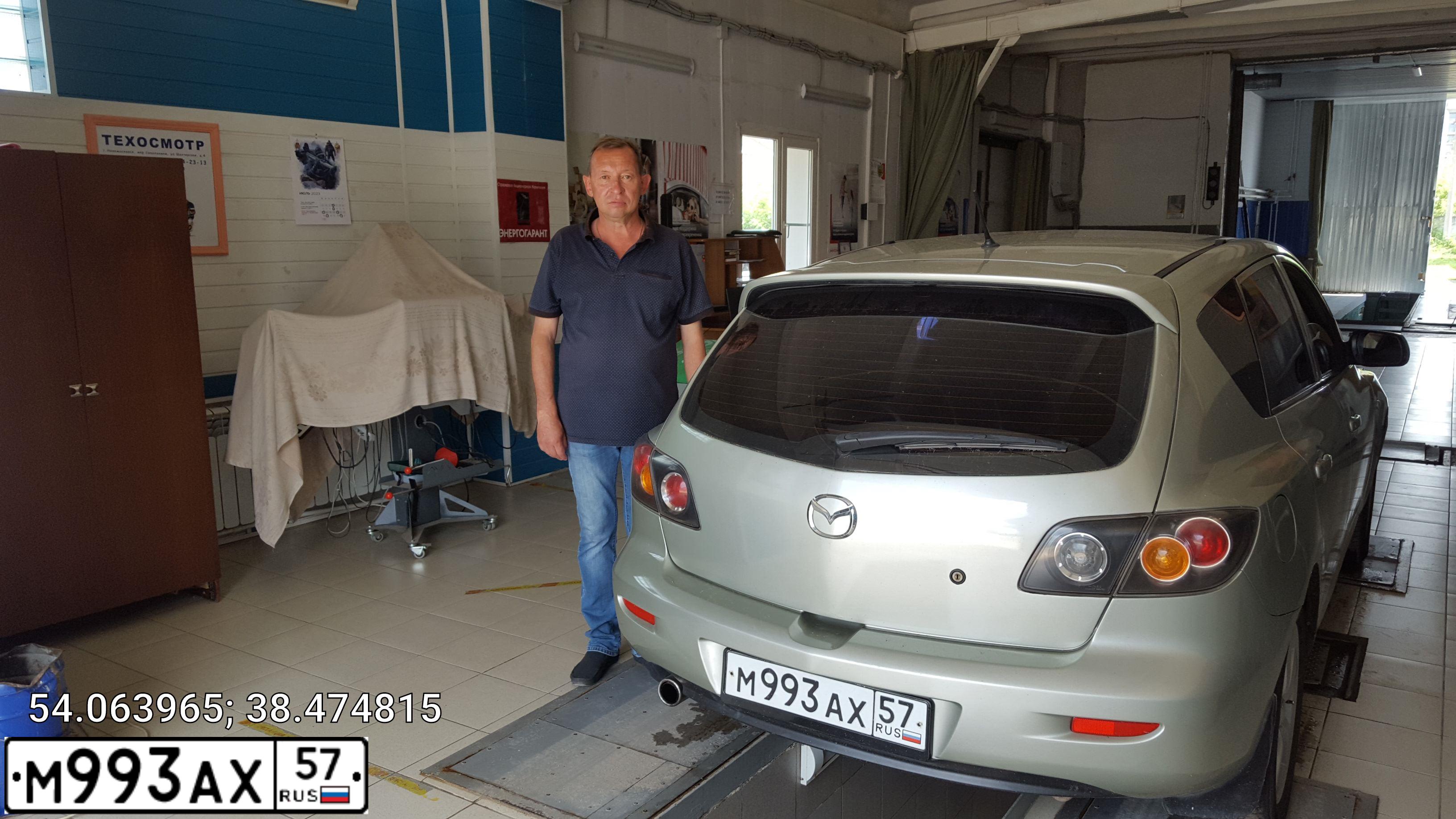 Фото автомобиля MAZDA A 3, 2005 — госномер О033ТР32. Цвет: СЕРО-ЗОЛОТИСТЫЙ