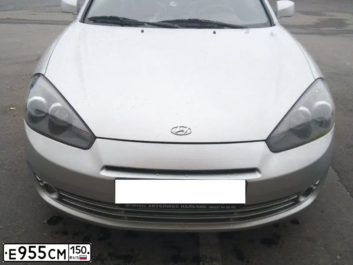 Фото автомобиля HYUNDAI /S-/COUPE / TUSCANI, 2008 — госномер Е955СМ150. Цвет: СЕРЕБРИСТЫЙ