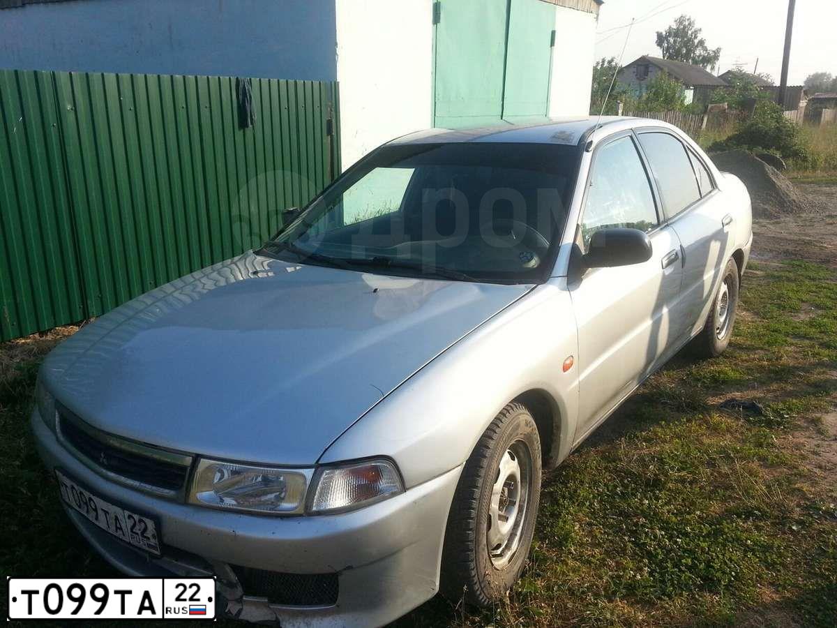 Фото автомобиля MITSUBISHI LANCER, 1999 — госномер Т099ТА22. Цвет: БЕЛЫЙ СЕРЕБРИСТЫЙ