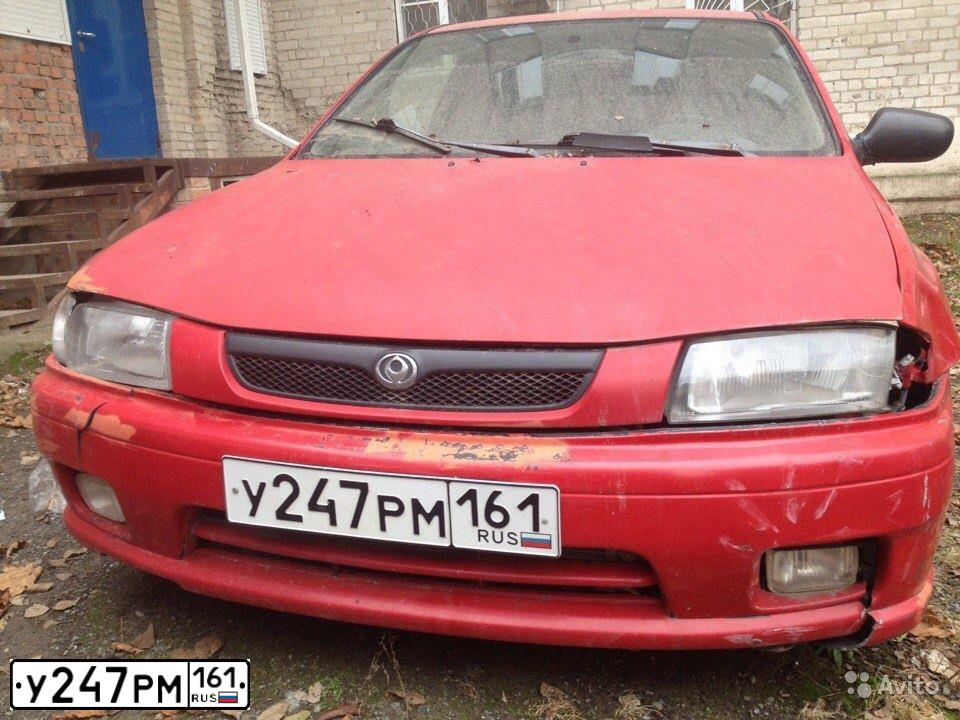 Фото автомобиля MAZDA 323, 1997 — госномер У247РМ161. Цвет: Красный