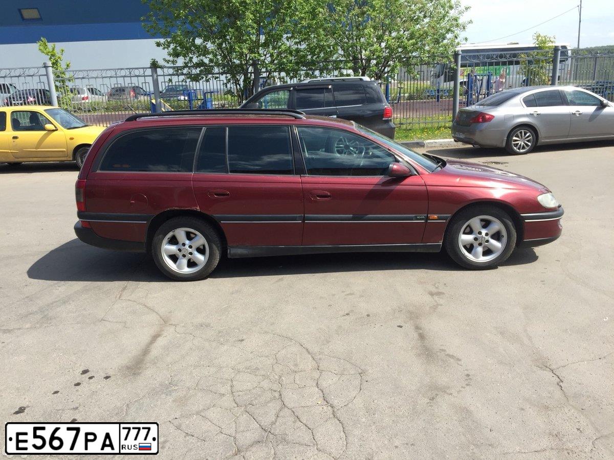 Фото автомобиля OPEL OMEGA, 1998 — госномер Т016АН550. Цвет: Красный