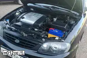 Фото автомобиля KIA SPECTRA, 2006 — госномер М012ОЕ02. Цвет: ЧЕРНЫЙ МЕТАЛЛИК