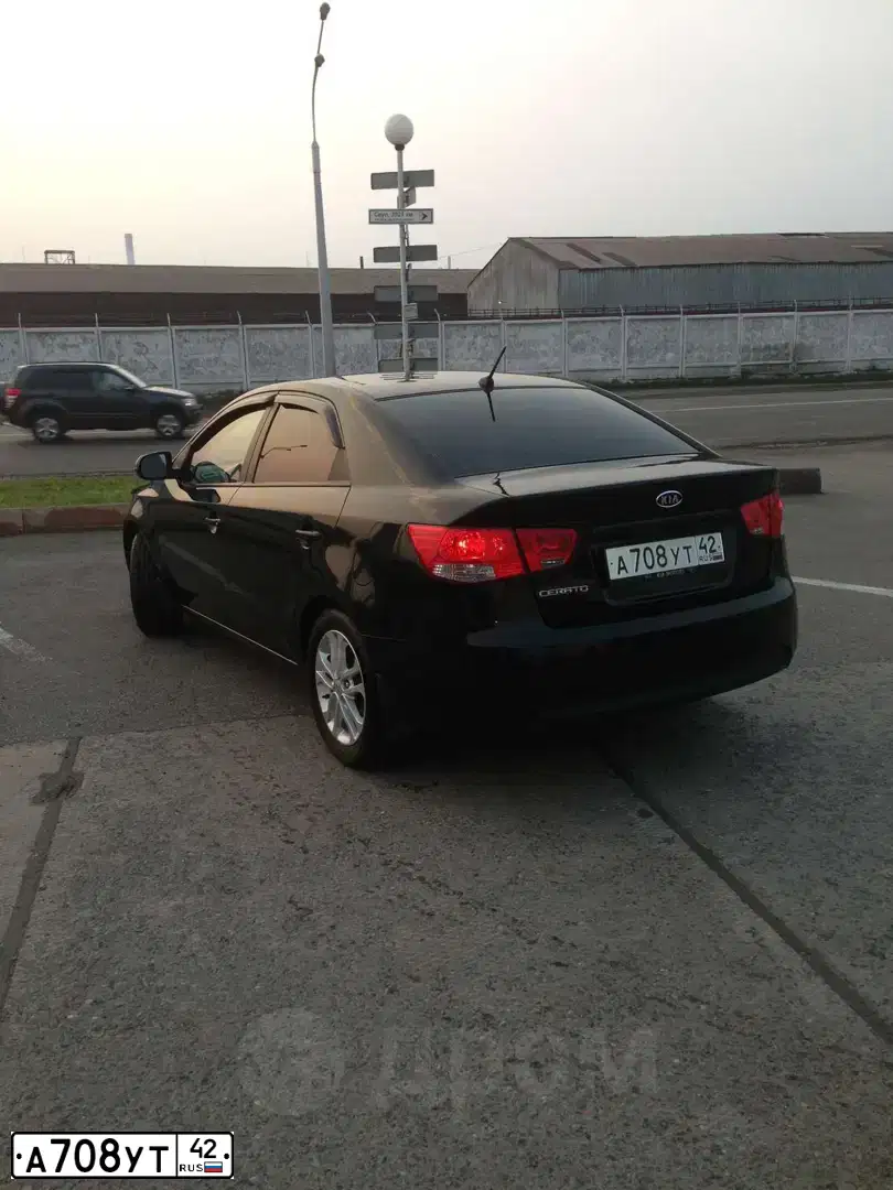 Фото автомобиля KIA CERATO, 2010 — госномер Н894СК70. Цвет: ЧЕРНЫЙ