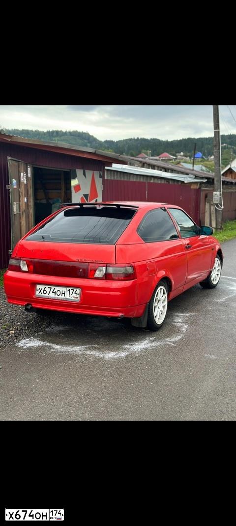 Фото автомобиля LADA 2112, 2007 — госномер Х674ОН174. Цвет: ЯРКО-КРАСНЫЙ