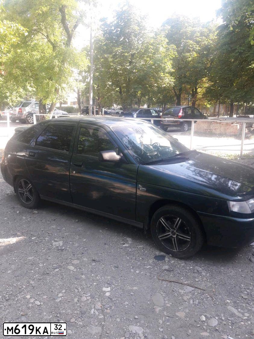 Фото автомобиля LADA 2112, 2004 — госномер Х716ВР199. Цвет: Темно-зеленый