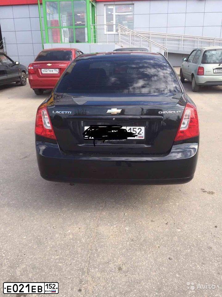 Фото автомобиля CHEVROLET AVEO, 2011 — госномер Е021ЕВ152. Цвет: Красный
