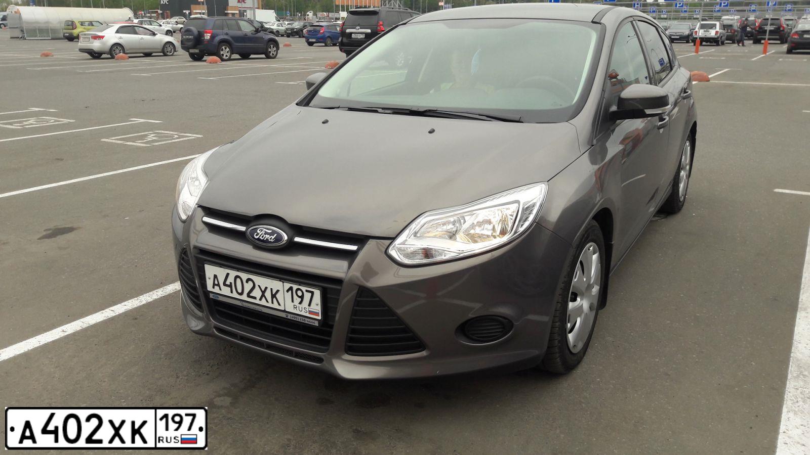Фото автомобиля FORD FOCUS, 2012 — госномер М015СУ69. Цвет: серо - коричневый