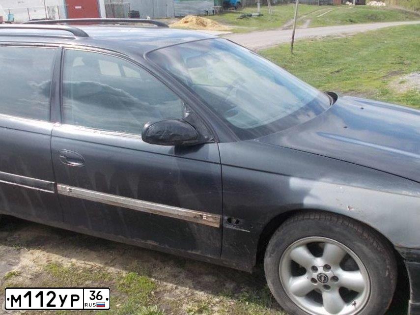 Фото автомобиля OPEL OMEGA, 1995 — госномер М112УР36. Цвет: ЧЕРНЫЙ