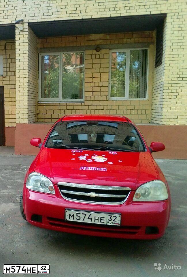 Фото автомобиля CHEVROLET LACETTI, 2008 — госномер К219ТУ82. Цвет: Красный