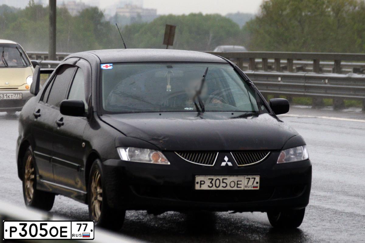 Фото автомобиля MITSUBISHI LANCER, 2005 — госномер К044АХ550. Цвет: ЧЕРНЫЙ